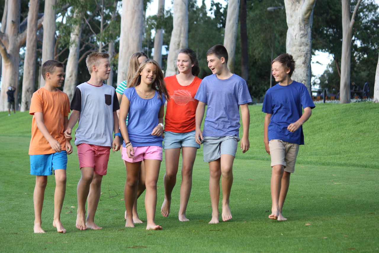 teenage friends walking in group